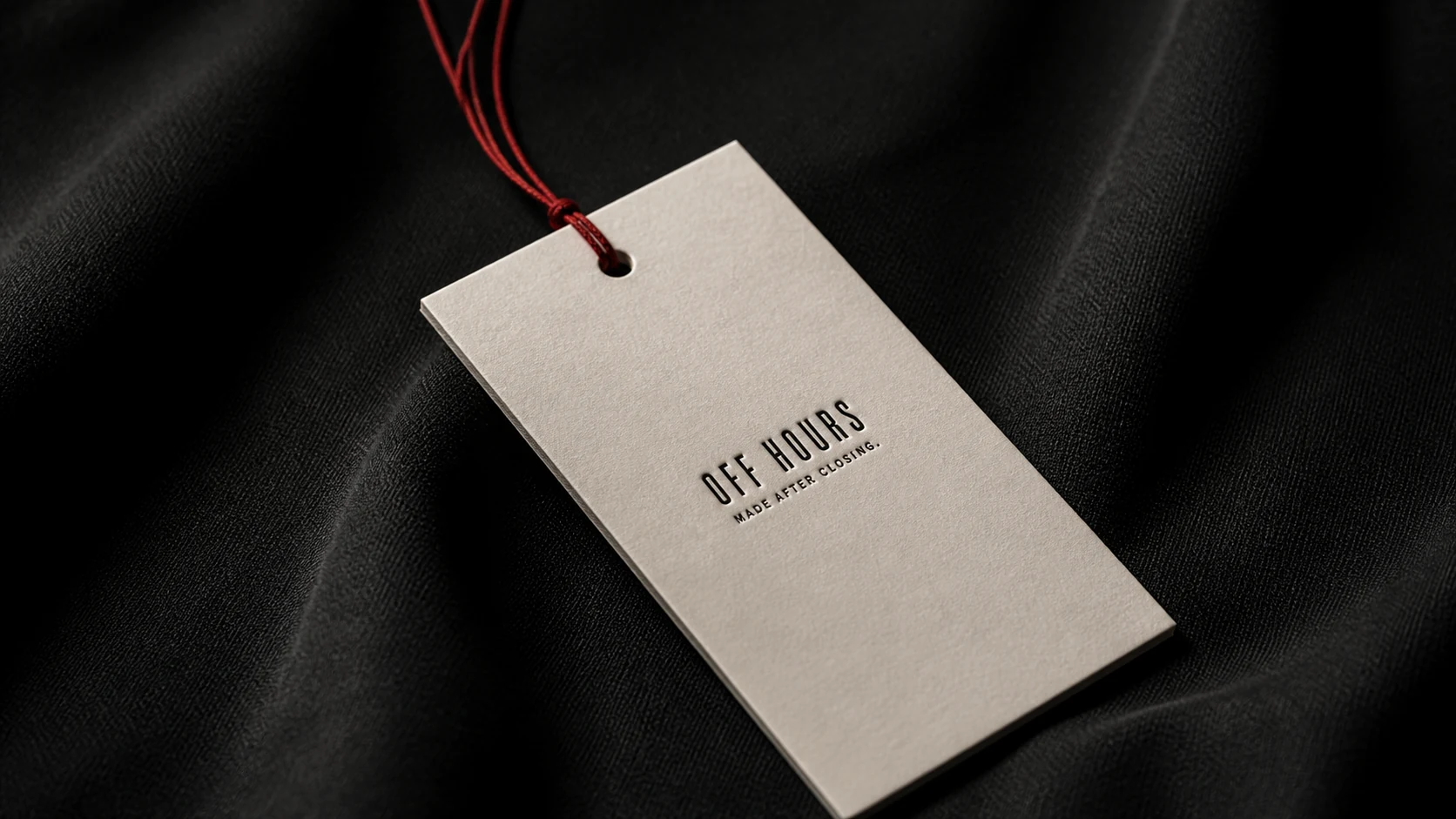 OFF HOURS hang tag on black fabric